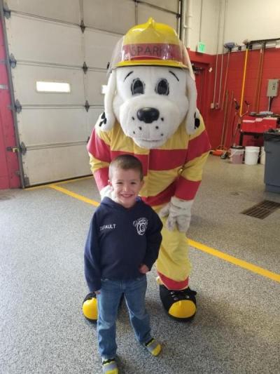 Sparky the Fire Dog with a young fan at the District No. 3 fire station. Photo courtesy: Fire District No. 3