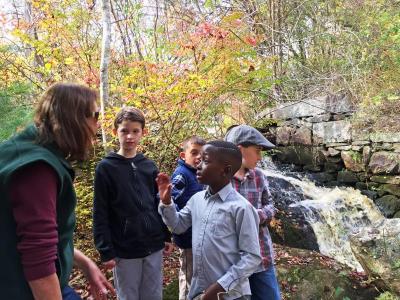 DNRT volunteer Carol Matthews discusses spillways with students.