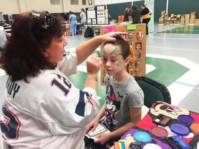 Emma Barber, 7, getting a butterfly face painting.