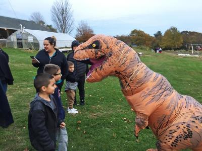 Children stare down a T-Rex (12-year-old volunteer Eliza Corral).