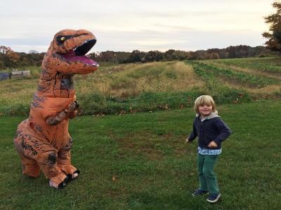Corral in her T-Rex costume says hello to four-year-old Henry Lofberg.