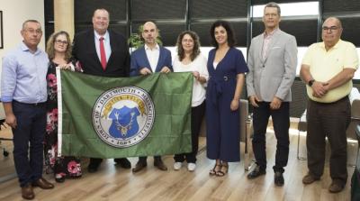 Jorge Cabrita, Louise and Shawn McDonald, President Luis Encarnacao, Vice-President Analbel Simao, and council members holding the Dartmouth flag. Photo courtesy: Shawn McDonald