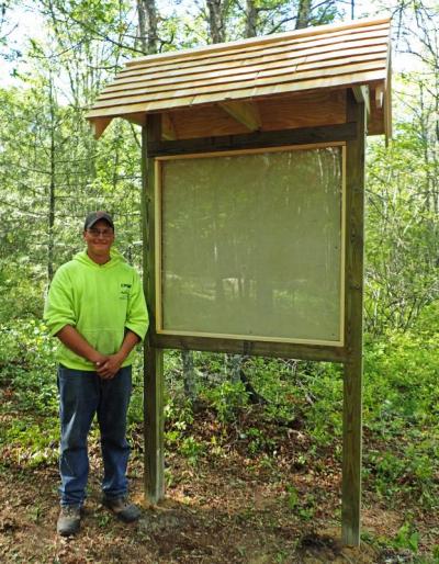 David Hughes of Troop 170 in front of the new kiosk he constructed at the Wernick Farm property on Chase Road. Photo courtesy: DNRT
