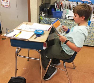 Some students still chose traditional desk seating, as nine-year-old Preston Pereira did.
