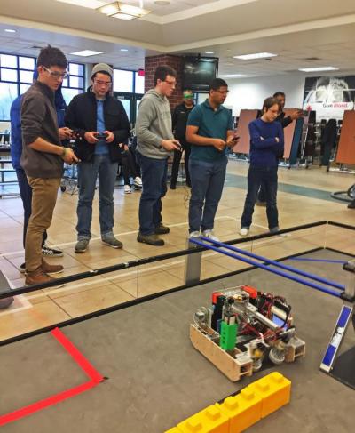 Nick McMaster (left) with the rest of the Alumineers watch their robot during the match.