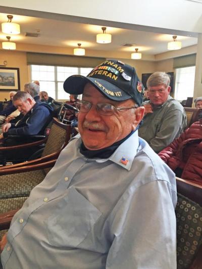 Vietnam veteran Leonard Quintin shows off his new flag pin after the ceremony.