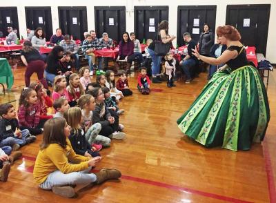 Dartmouth, MA news - The Snow Princess sings a song while children sing along.