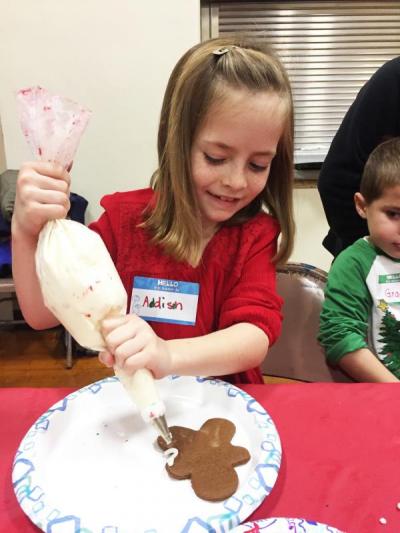 Dartmouth, MA news - Addison LaBelle, 7, starts icing her gingerbread man.
