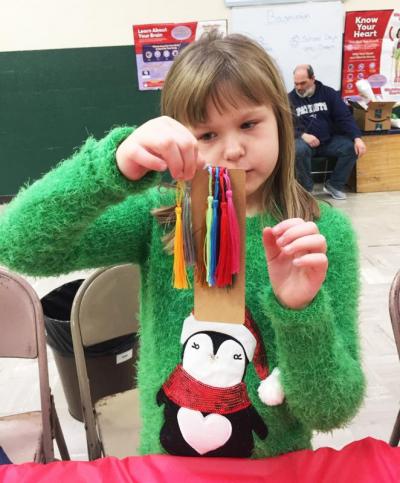 Dartmouth, MA news - Eight-year-old Emma Koski shows off her bookmark with multiple tassels. “I want one of each,” she said.