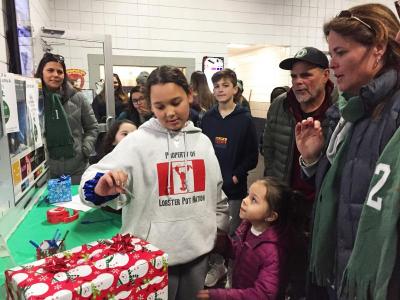 Dartmouth, MA news - sports - Ten-year-old Letty Nelson, whose older brother Joshua is on the team, drew the tournament raffle prize winners between the second and third periods