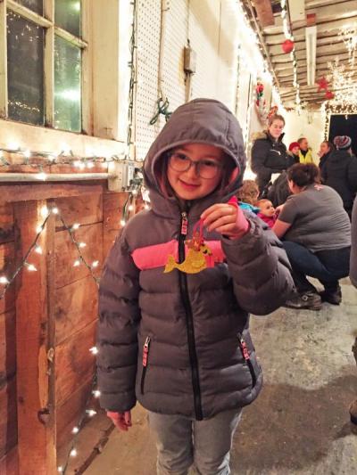 Seven-year-old Dylan Laporte shows off her Christmas ornament.