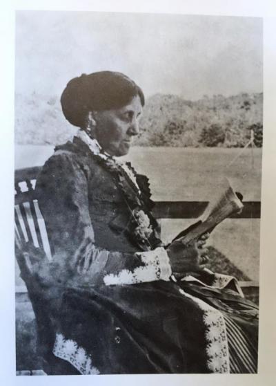 Louisa May Alcott reading on the porch of the Nonquitt Hotel, c. 1883. The hotel burned down in 1893. From “Nonquitt: A Summer Album, 1872-1985”, edited by Anne Morse Lyell.