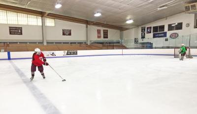 Dartmouth, MA news - sports - Freshman Jordan Theriault sets up for a slapshot against a defender and goalie Sophia Babineau