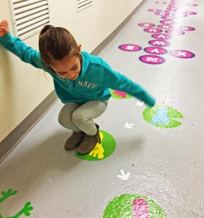 Dartmouth, MA news - Six-year-old Emily Cabral jumps on the new sensory path at Cushman School. Photos by: Kate Robinson