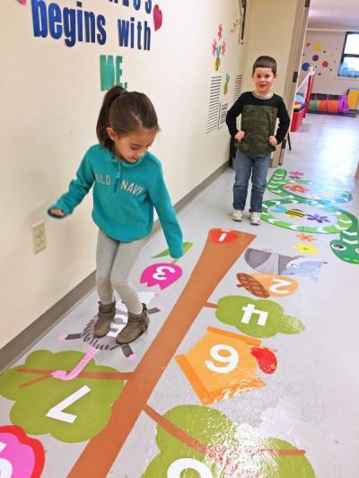 Dartmouth, MA news - Cabral hops on the numbers tree while Andrew Ferreira, 6, watches