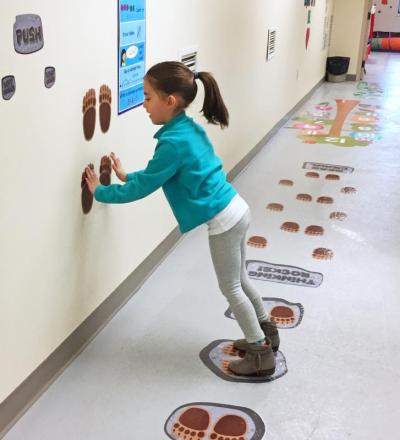 Dartmouth, MA news - Cabral does a wall push-up for the ‘bear hunt’ path activity