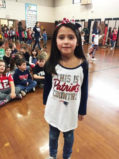 First grader Amelia Guerreiro showed off her Patriots-themed shirt before the assembly