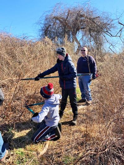 Scouts Landon Borges and Charlie Fernandez clearing the trail under the watchful eye of Corey Ferreira