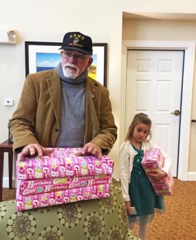 Alan Gifford and Emma Keaney, 6, help carry presents