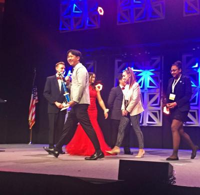 Colin Zhu accepting his first place trophy onstage. Photo courtesy: Patricia Kane