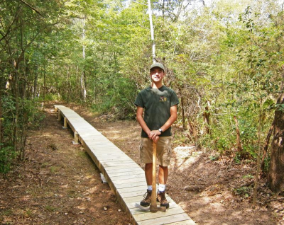 Jonathan Bacdayan from Troop 170 shows off the boardwalk he built at DNRT’s Star of the Sea reserve. Photo courtesy: Dartmouth Natural Resources Trust