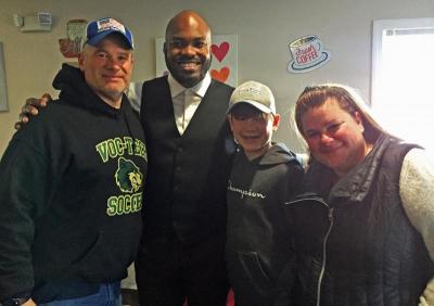 Eric Martin poses for a photo with Patriots fans Mark, 14-year-old Brady, and Erica Kruger.