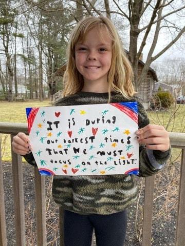 Dartmouth Week - Dartmouth, MA news - Third grader Avery Parker with a quote in a photo posted to the Dartmouth Police Department’s Facebook page. Photo courtesy: DPD