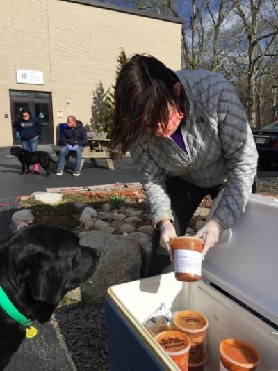 Dartmouth Week - Dartmouth, MA news - Church takes a container of soup while her dog Abby looks on