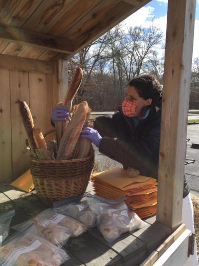 Dartmouth Week - Dartmouth, MA news - Head of School Sarah Herman takes some bread for the families