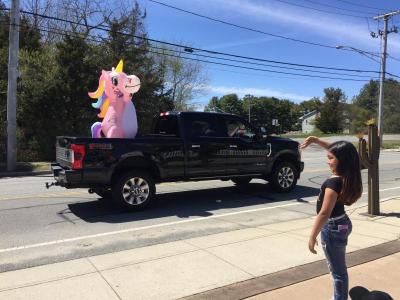Dartmouth Week - Dartmouth, MA news - A’Mya waves to a large inflated unicorn during the drive-by party