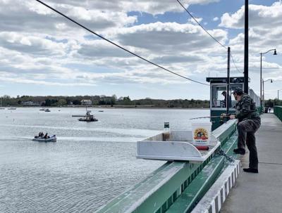 A man fishes on the Padanaram bridge. Photo by: Christopher Shea