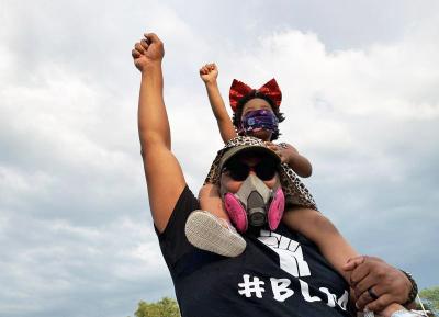 Peter Walker with daughter Nyla during a Black Lives Matter march through Dartmouth on June 6. Photo by: Christopher Shea