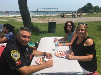 Dartmouth Police Officer Rich Medeiros shares a table with Donna Fernandes, center, and Sue Gonsalves.
