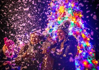 Nicole Kloss (right) poses for a photo with her daughter Caroline, 3, and her mother Rosa Catulo as fake snow cascades down on them at the Padanaram Christmas Stroll on Dec. 2. Photo by: Morgan Beard