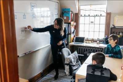 Megan O'Brien, a learning specialist, teaching literacy to two fifth graders. This is a typical structured literacy session for students in the Sally Borden Program. Source: Alicia Porter