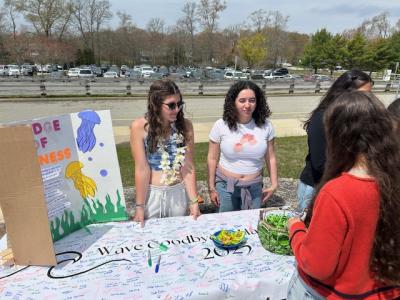 Students Molly Cunningham and Aubrey Negron encourage their peers to take the No Place for Hate pledge.
