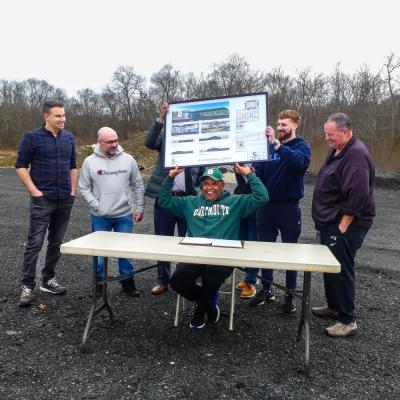 (Back row) Board members Ray Medeiros, Geoffrey Faucher, Alekz Hirschmann, Preston LaBonte and Graham Gisherman and Select Board Vice Chair Shawn McDonald celebrate the signing of the lease with Steve Burgo, front.