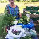 Eileen Paccia shows off the produce from her CSA at Brix Bounty
