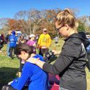 Kelsey Heston of Milton Chiropractic uses a hand tool to massage Bianca Garcia after the race.