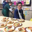 Austin Santos takes a break from plating up apple pies.