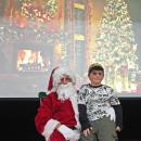 Dartmouth, MA news - Nine-year-old Preston Pereira sits on Santa’s lap on the stage.