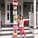 Quinn School first grader Londyn Edgcombe with her tower of books. Photo courtesy: Greg Edgcomb