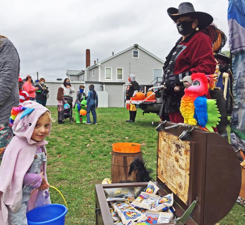Emelia Fairclough, 3, grabbing a snack from the pirates. Dartmouth Week - Dartmouth, MA news - Emelia Fairclough, 3, grabbing a snack from the pirates.