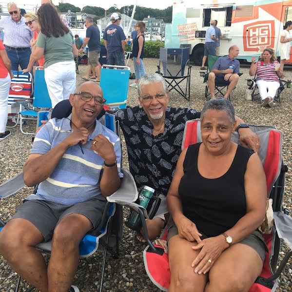 From left, Frank Pina, Mike Monteiro and Stephanie Pina listen to the band.