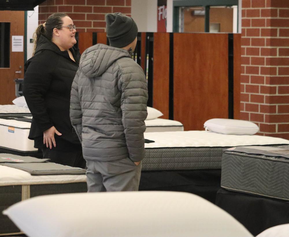 A customer views the mattress inventory.