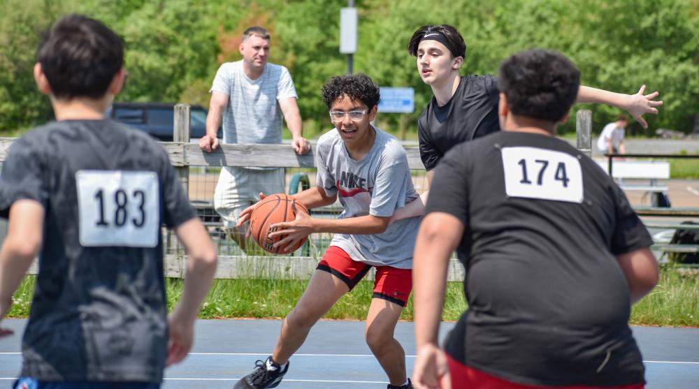 Miguel Flores looks for an opening to pass during a Burgo Basketball draft game for the summer league Sunday, May 26. Photos by Leighah Beausoleil