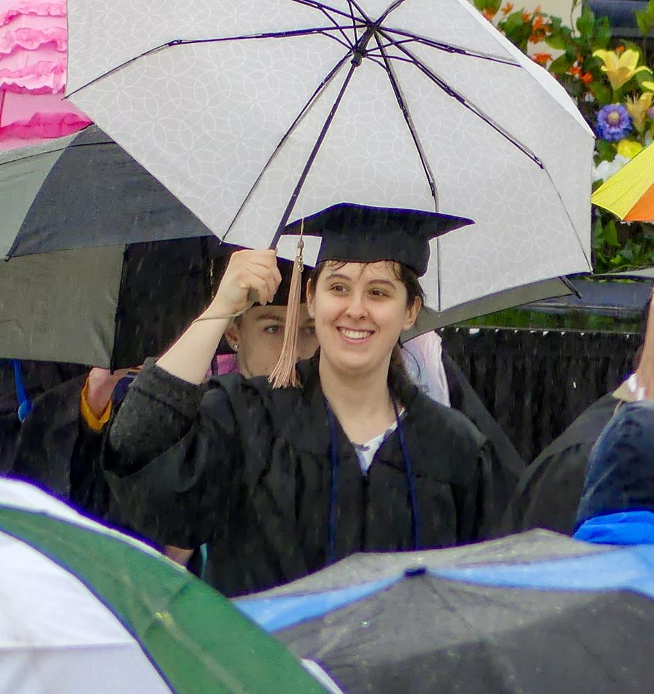 The rain doesn’t dampen the students’ spirits.