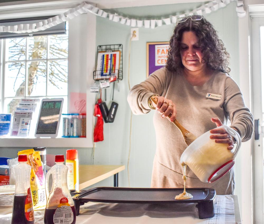 Rochelle Whalen, membership and program director, begins cooking up the pancakes.