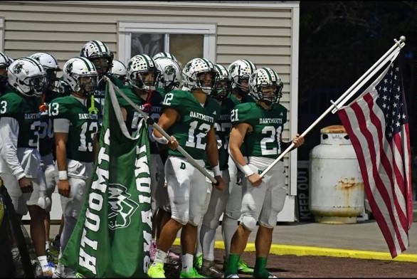 Jackson Hart and his team carry flags out onto the field. Source: Jackson Hart