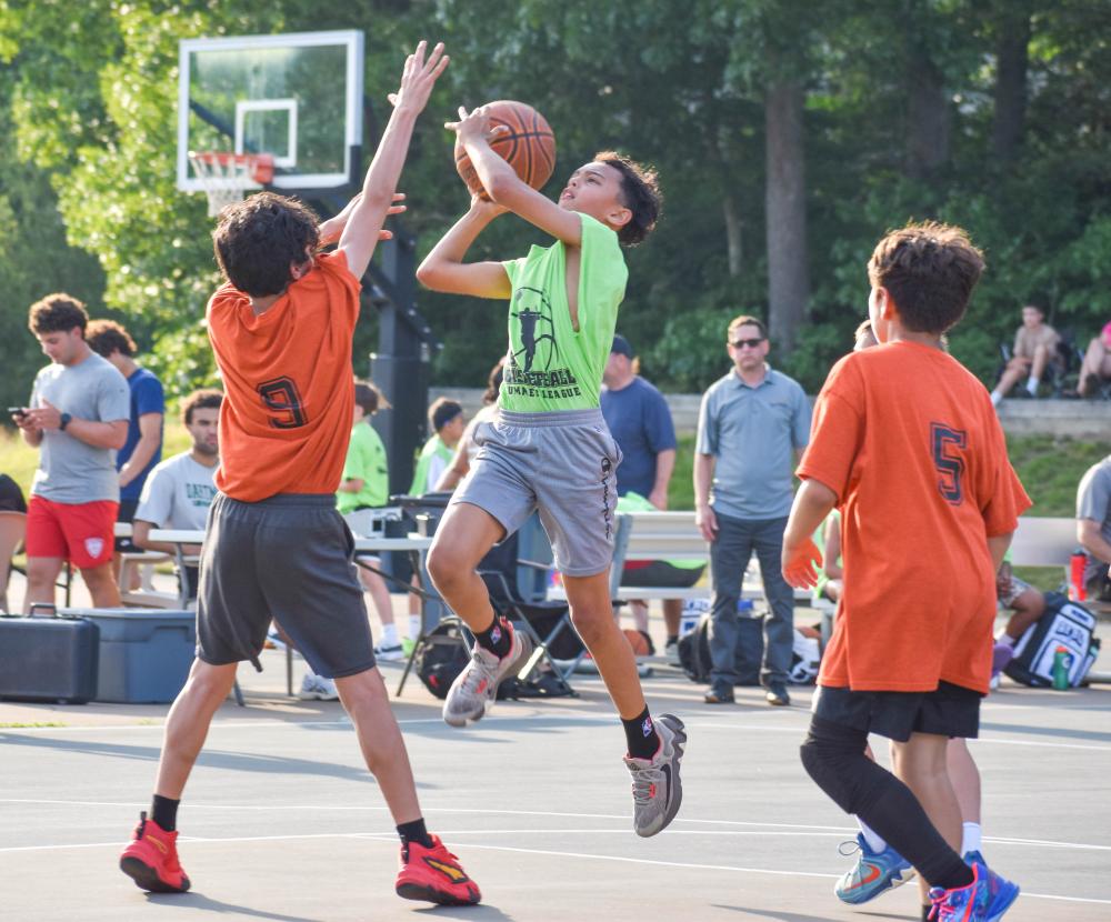 Preston Casteel attempts a basket during a Burgo Basketball league game this summer.